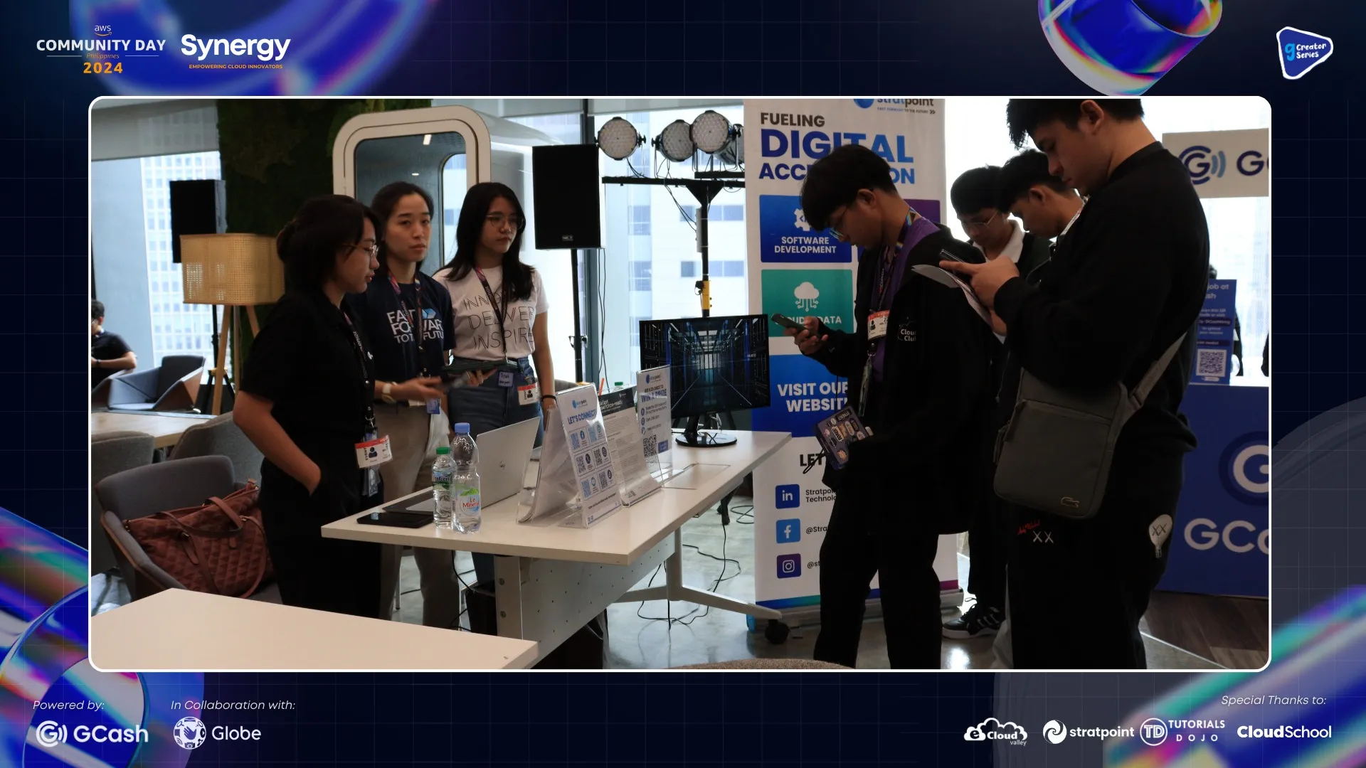 Participants engaging at a tech booth